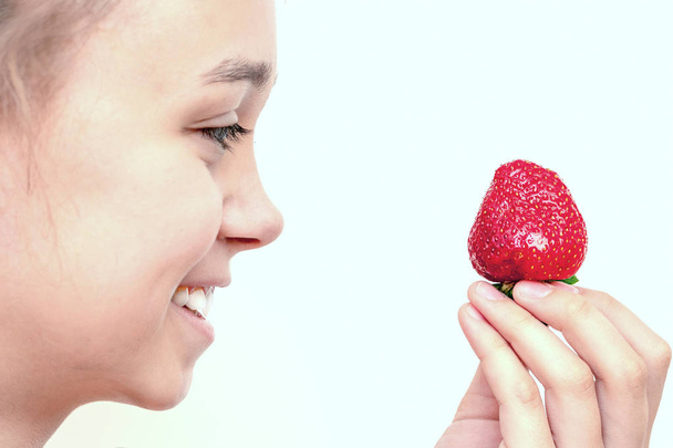 Portrait of yaung woman eating strawberries. Healthy happy smiling woman eating strawberry. Healthy, lifestyle concept.  - 写真・画像