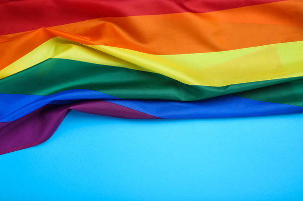 Rainbow flag on blue background - Φωτογραφία, εικόνα