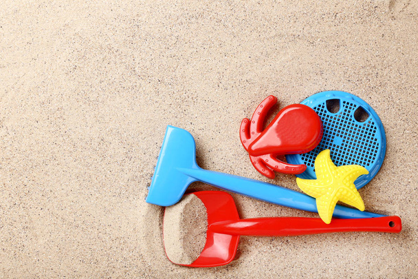 Plastic toys on beach sand - Fotoğraf, Görsel