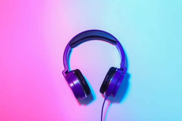 Stylish headphones on color background, top view - Foto, Imagem