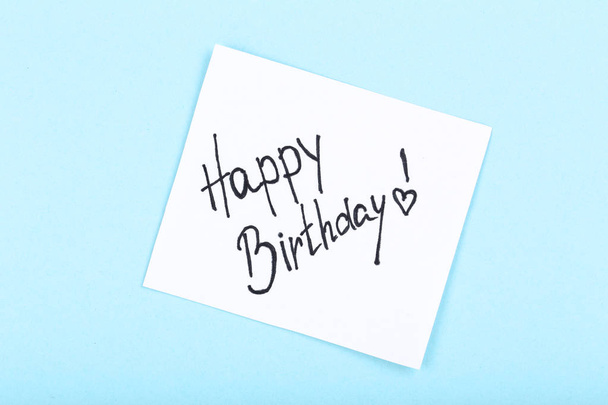 Paper with text Happy Birthday on blue background - Zdjęcie, obraz