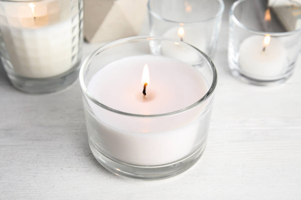 Burning aromatic candle in holder on table - Photo, Image