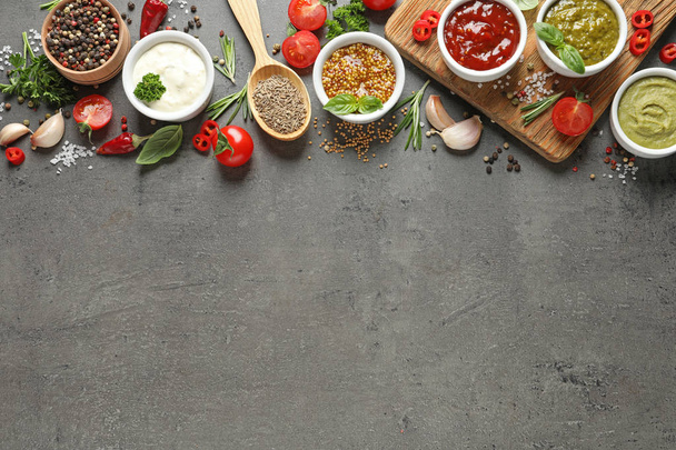 Flat lay composition with different sauces and space for text on gray background - Foto, immagini