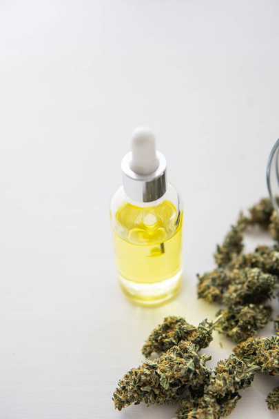 medical marijuana concept, close up, hemp product, CBD cannabis OIL. bottle of Cannabis oil in pipette, vertical shot - Foto, imagen
