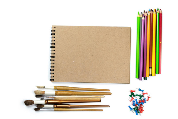 Colored pencils, brushes, notebook mock up for artwork with watercolor paints. Branding stationery mockup scene, blank objects for placing your design. - Photo, Image