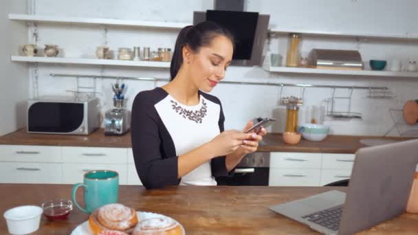 Beautiful Pretty Lady Holding Smartphone on Kitchen - Filmmaterial, Video
