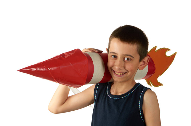 Boy with toy red and white rocket on his shoulder isolated on white - Photo, image