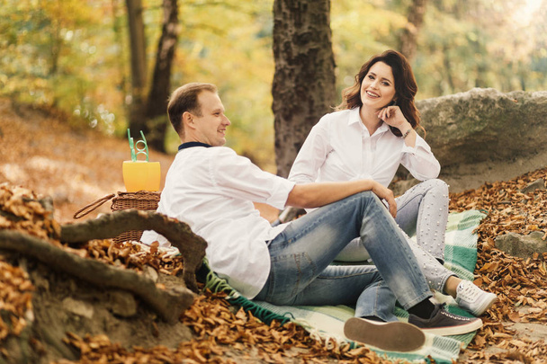 Romantic young couple walking in autumn park. Family together in the park. Pregnant couple. - Foto, Bild