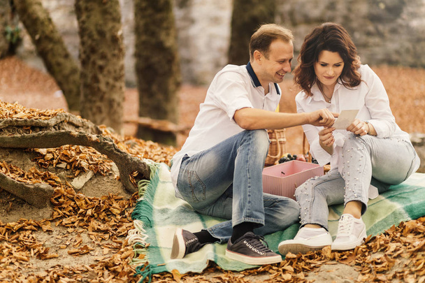 Romantic young couple walking in autumn park. Family together in the park. Pregnant couple. - Fotoğraf, Görsel