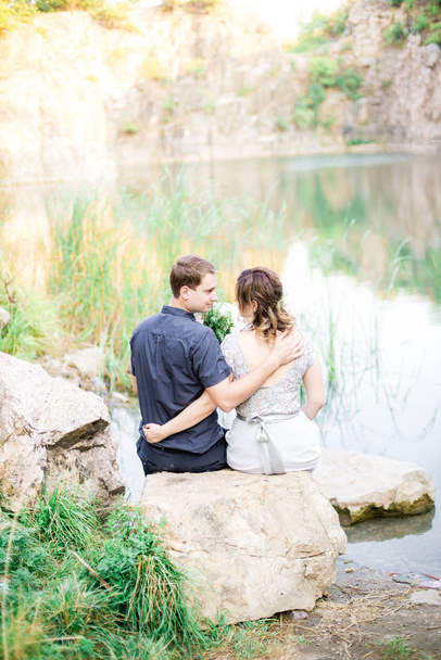 Elegant gentle stylish groom and bride near river or lake. Wedding couple in love  - Fotografie, Obrázek
