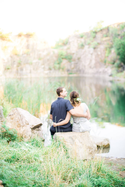 Elegant gentle stylish groom and bride near river or lake in summer. Wedding couple in love  - Photo, Image