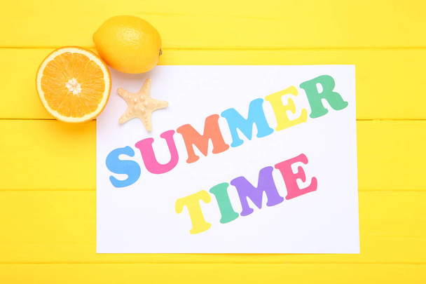 Word Summer Time with starfish and orange fruits on yellow woode - Photo, image
