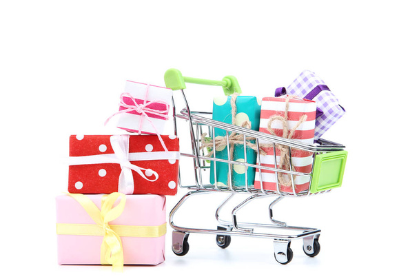 Small shopping cart with gift boxes isolated on white background - Foto, afbeelding