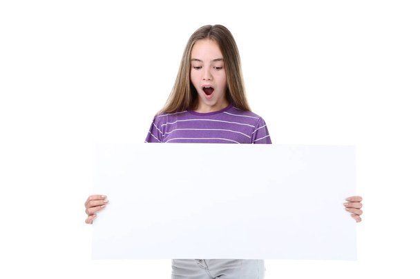 Surprised young girl holding blank board on white background - Foto, Imagen
