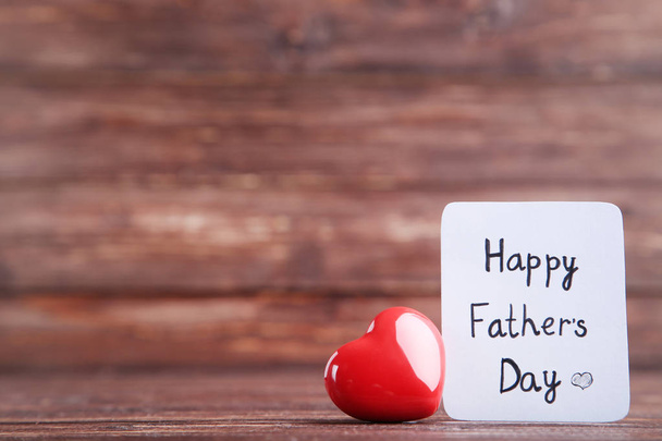 Text Happy Fathers Day with red heart on wooden table - Fotoğraf, Görsel