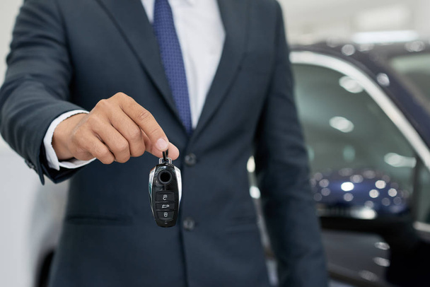 Car dealership sales manager giving keys, selective focus - Photo, Image