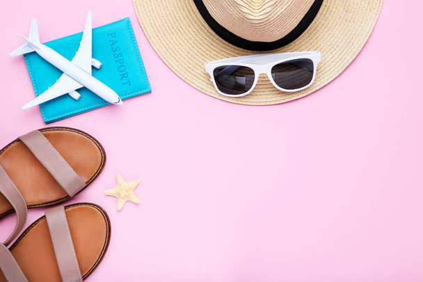 Fashion clothing with passport and airplane model on pink backgr - Φωτογραφία, εικόνα