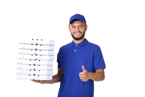 Delivery man with pizza in cardboard boxes isolated on white bac - Fotó, kép
