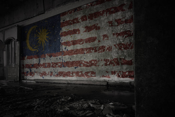 ζωγραφισμένα σημαία της Μαλαισίας στον βρώμικο παλιό τοίχο σε ένα εγκαταλελειμμένο ερειπωμένο σπίτι. - Φωτογραφία, εικόνα