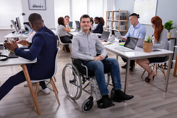 Portrait Of A Disabled Businessman On Wheelchair At Office - Foto, Bild