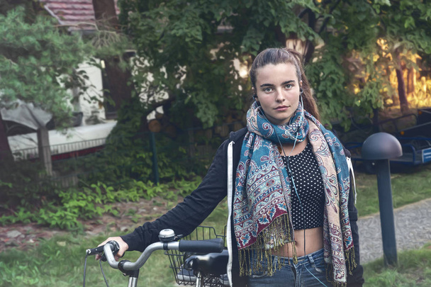 portrait of a young woman with bicycle - Photo, Image