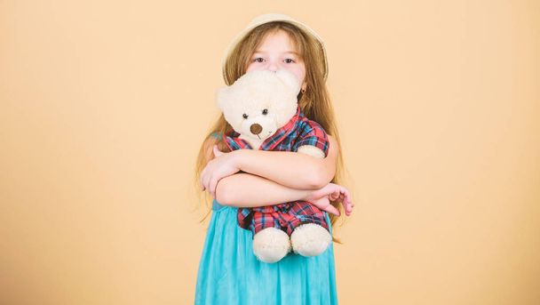Her favorite toy. Little girl holding soft toy. Small child cuddling teddy bear toy. Adorable girl child with cute stuffed animal doll. Toy is used in play - Photo, image