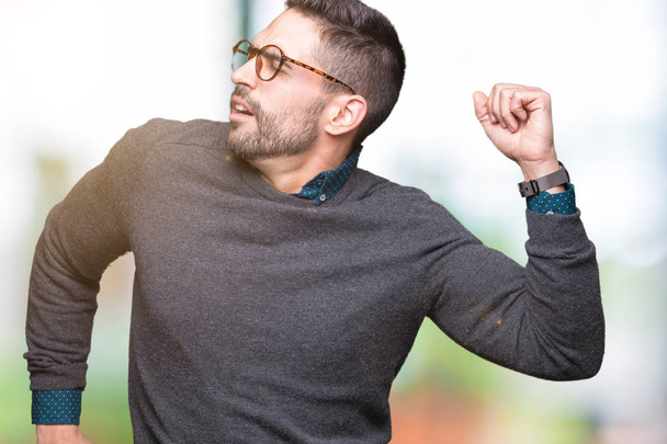 Young handsome man wearing glasses over isolated background stretching back, tired and relaxed, sleepy and yawning for early morning - Foto, imagen
