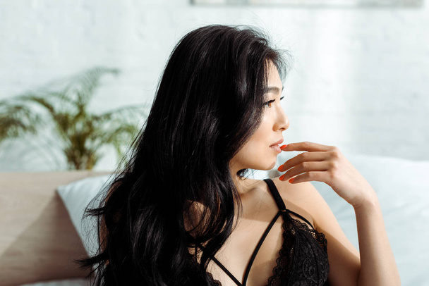 sexy asian woman in black lace bra in bedroom  - Fotó, kép