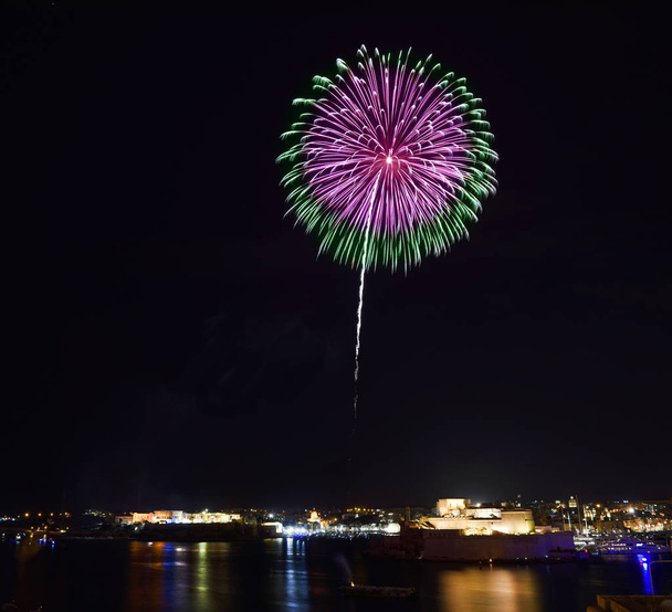 Amazing fireworks explode with Fort St Angelo in Birgu in the background. Malta fireworks festival at 2019. Fireworks. - Photo, Image