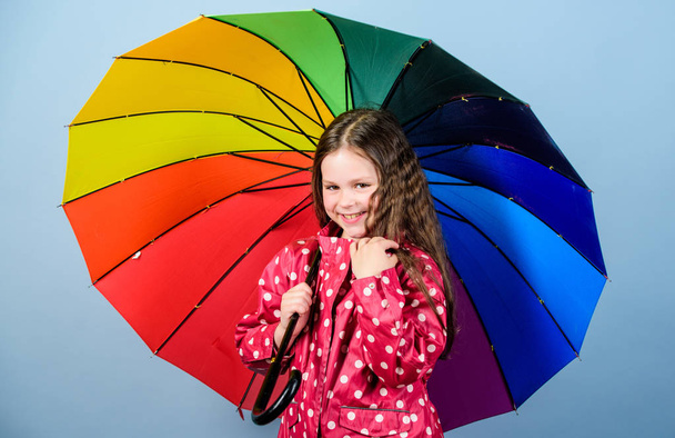 cheerful hipster child in positive mood. rain protection. Rainbow. happy small girl with colorful umbrella. Small girl in raincoat. autumn fashion. Feeling the nature. So beautiful - Valokuva, kuva