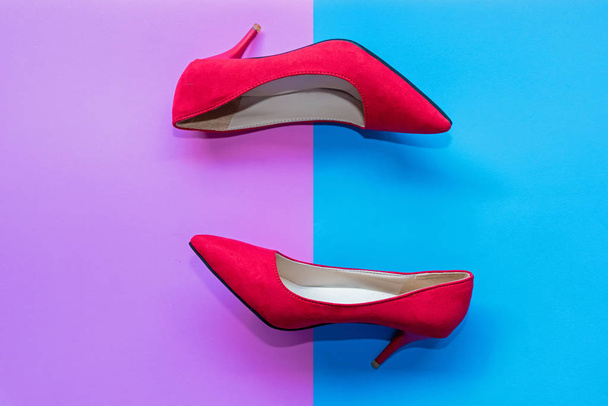 Fashion woman accessories set. Trendy red fashion shoes heels. Pink and blue pastel color background. Fashion and Lifestyle Concept. - Фото, зображення