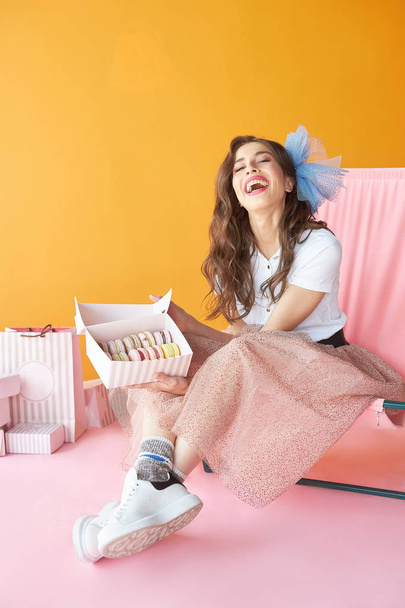 Confectioner woman sitting on chair near pastry boxes. Candy woman.  - Foto, Imagem