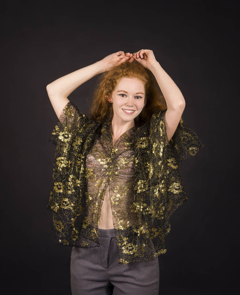 Emotional, red-haired girl in a brocade blouse posing. - Foto, imagen
