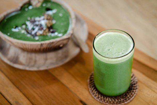 Glass of green celery juice on wooden table - Photo, Image