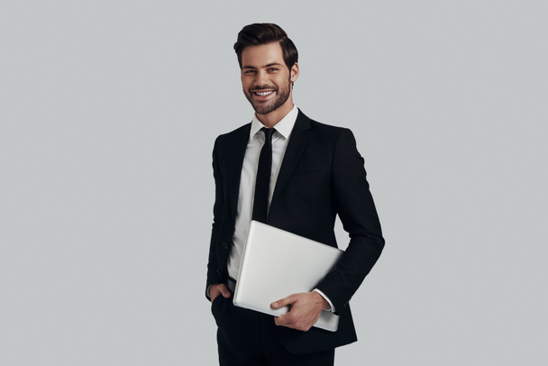 moderner Geschäftsmann. schöner junger Mann in vollem Anzug trägt Schoß - Foto, Bild