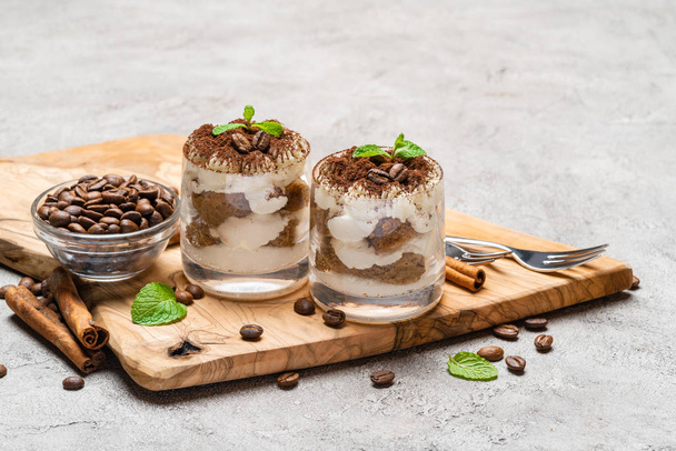 Classic tiramisu dessert in a glass on dark concrete background - Photo, Image