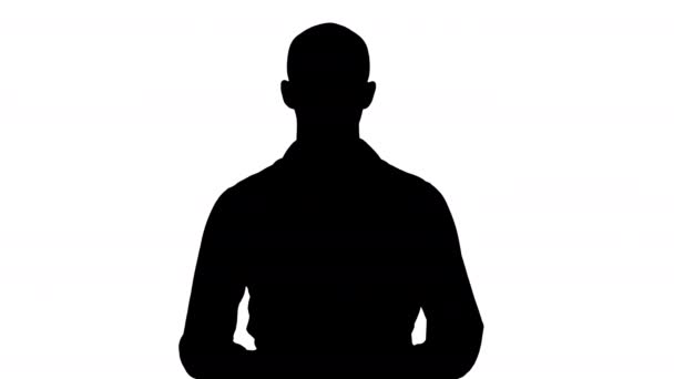 Silhouette Arabic young man in shirt talking presenting something and pointing to the side. - Footage, Video
