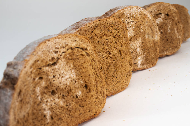 Sliced rye bread covered with mold. - Photo, Image