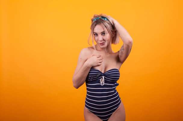 Beautiful blonde model in blue beachwear and swimming glasses - Photo, Image