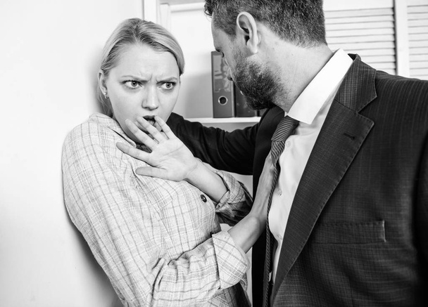 Unacceptable violent behavior. Prevalence of violence and harassment at workplace. Woman worker scared by brutal boss threatening violence. Domination concept. Girl victim office violence concept - Foto, Bild