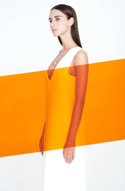 Orange limelight line in front of stylish female - Photo, image