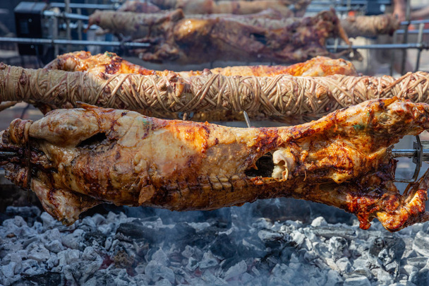 Greek Easter custom. Kokoretsi, kokorec and lamb, sheep, kid grilling on spits over charcoals fire. - Photo, Image