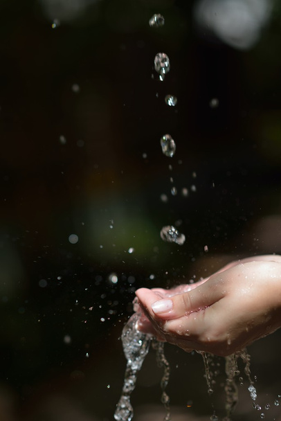 water stream on woman hand - Fotó, kép