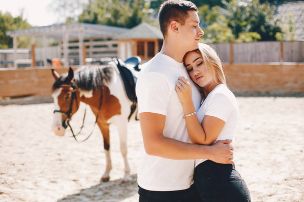 Beautiful couple spend time with a horses - Fotografie, Obrázek