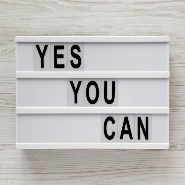'Yes you can' words on a light box over white wooden surface, to - Photo, Image