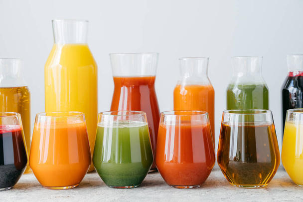 Set of glass jars with multicolored drinks standing in row. Fresh juice made of different fruit isolated over white background. Summer drink - Φωτογραφία, εικόνα