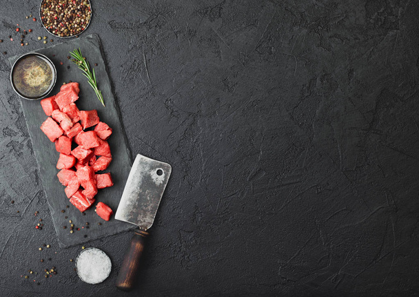 Raw lean diced casserole beef pork steak on chopping board with  - 写真・画像