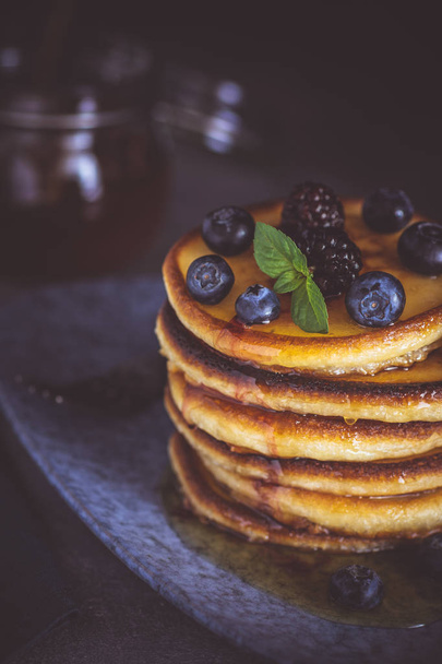 Pancakes with Fresh Berries and Maple Syrup on Dark Background. Classic American Homemade Breakfast. - Photo, Image