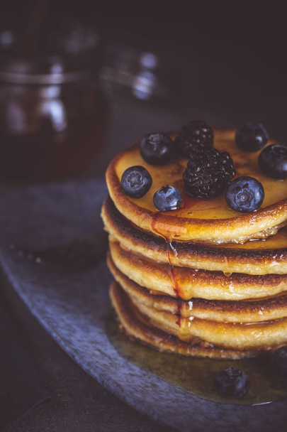 Pancakes with Fresh Berries and Maple Syrup on Dark Background. Classic American Homemade Breakfast. - Fotoğraf, Görsel
