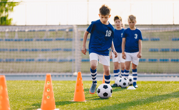 Junior soccer players developing soccer dribbling skills - Photo, Image